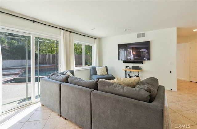 living area featuring light tile patterned floors, visible vents, baseboards, and recessed lighting