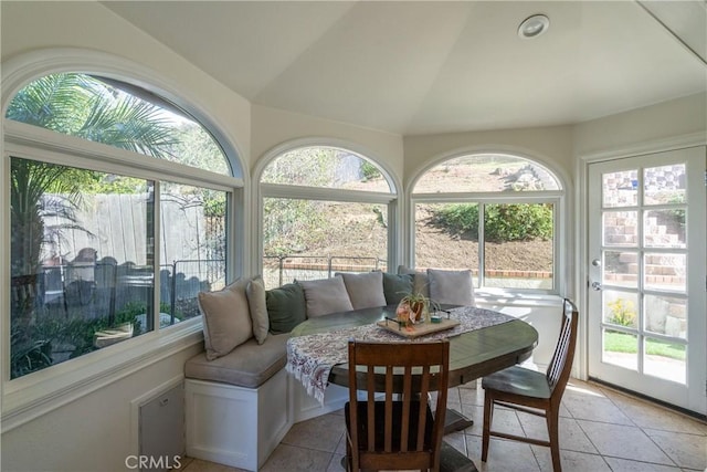 sunroom featuring vaulted ceiling