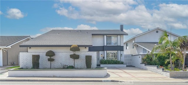 view of front of home with brick siding and stucco siding