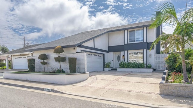 view of front of property with stucco siding, concrete driveway, and a garage