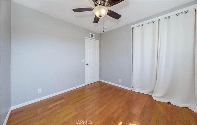 spare room featuring visible vents, light wood-type flooring, and baseboards