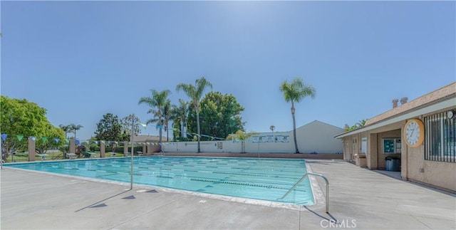 pool featuring a patio and fence