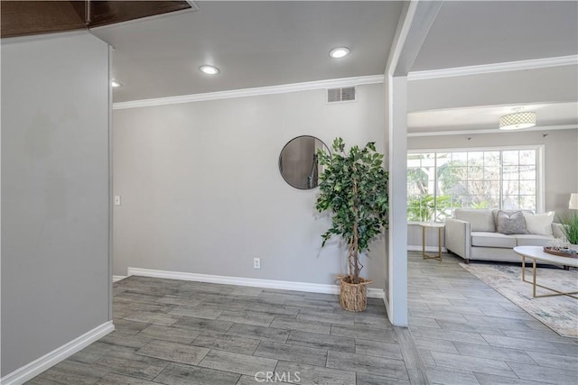 interior space featuring visible vents, crown molding, wood finish floors, baseboards, and recessed lighting