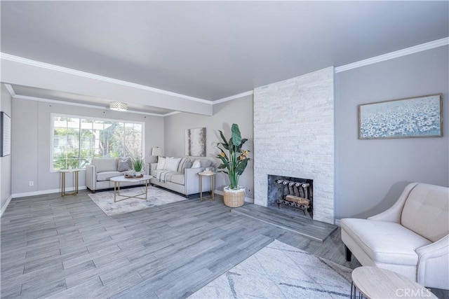 living area with a stone fireplace, wood finished floors, baseboards, and ornamental molding