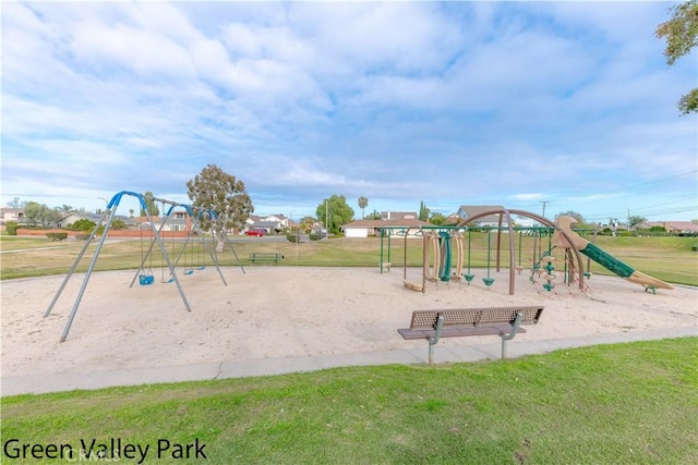 communal playground featuring a lawn