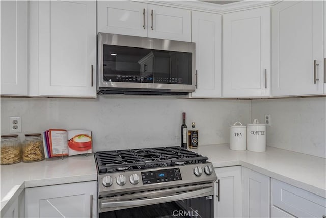 kitchen with white cabinetry, light countertops, and stainless steel appliances