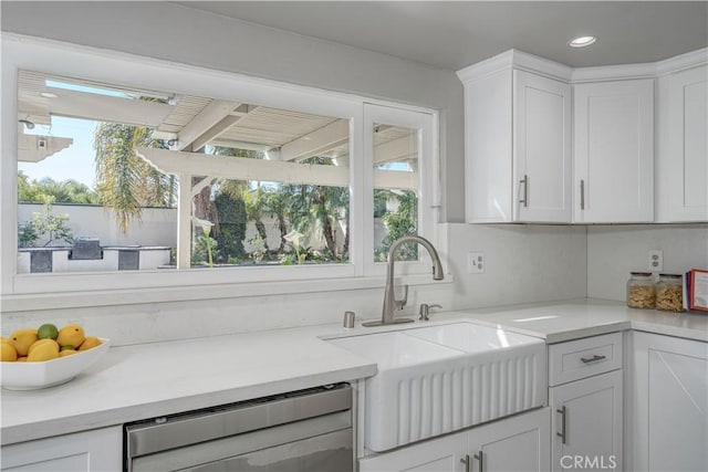 kitchen with white cabinetry, recessed lighting, a sink, light countertops, and dishwasher