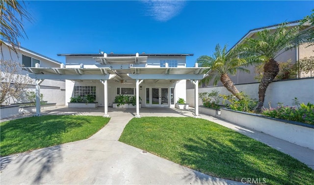 back of house featuring fence, french doors, a yard, a pergola, and a patio