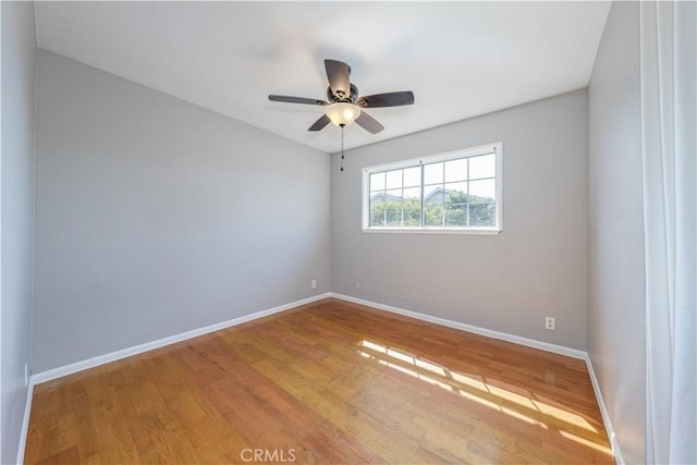 unfurnished room with ceiling fan, baseboards, and wood finished floors