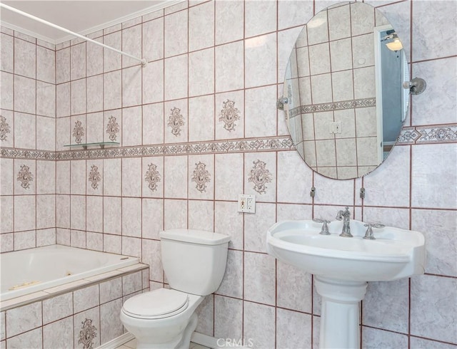 bathroom with a relaxing tiled tub, toilet, tile walls, and crown molding