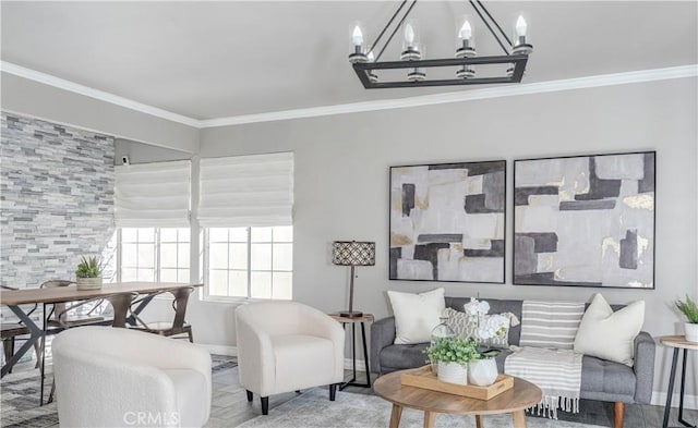 living room with a notable chandelier, wood finished floors, baseboards, and ornamental molding