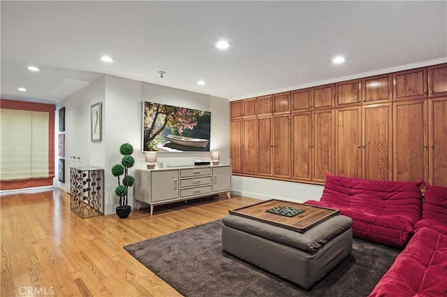 living area with recessed lighting and light wood-style floors