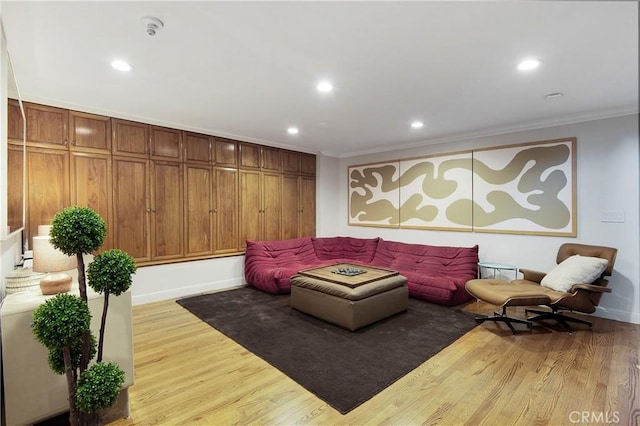 living area featuring crown molding, recessed lighting, and wood finished floors