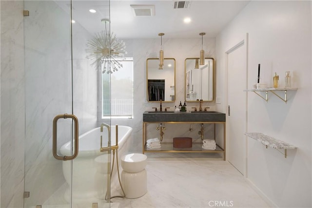 full bathroom with visible vents, a stall shower, a freestanding bath, and a sink