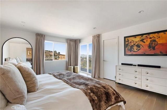 bedroom featuring recessed lighting, light wood-style flooring, and access to outside