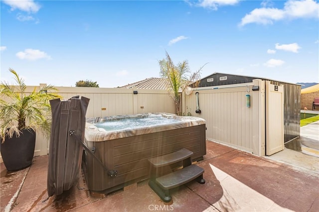 view of patio with fence and a hot tub