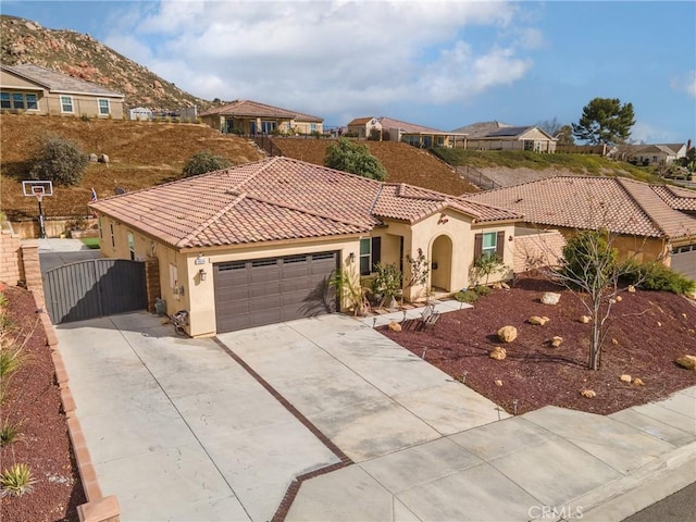 view of front of property with stucco siding, a garage, and a tile roof