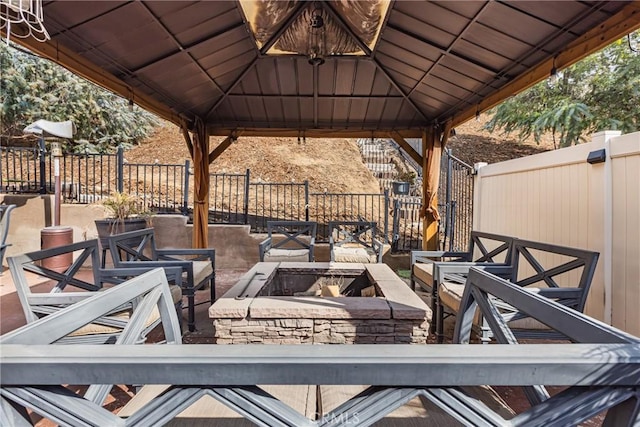 view of patio / terrace featuring a gazebo, a fire pit, and fence