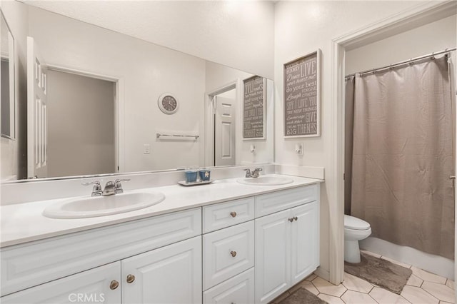 full bathroom featuring a sink, toilet, double vanity, and tile patterned flooring