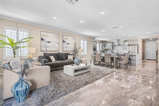 living room featuring visible vents, marble finish floor, ornamental molding, and a healthy amount of sunlight