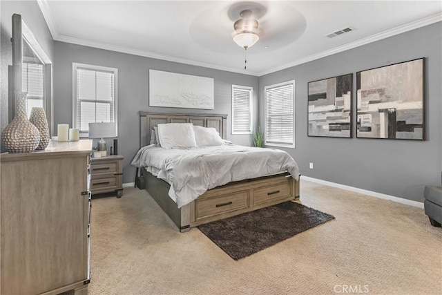 bedroom with ornamental molding, multiple windows, visible vents, and light carpet