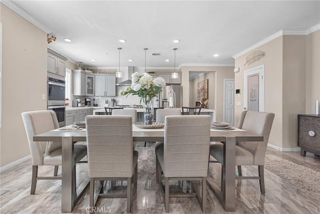 dining room featuring visible vents, baseboards, and ornamental molding