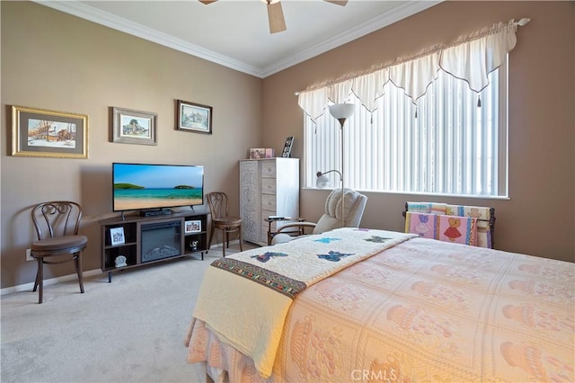 bedroom with ceiling fan, baseboards, carpet floors, and ornamental molding