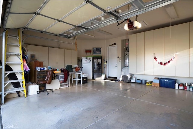 garage with strapped water heater, a garage door opener, and freestanding refrigerator