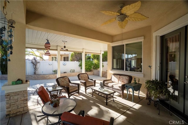 view of patio with a ceiling fan, fence, and an outdoor hangout area