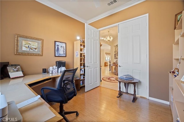 home office with visible vents, baseboards, light wood-style flooring, arched walkways, and crown molding