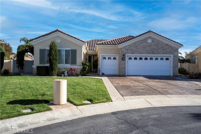 view of front facade with a front yard, driveway, stucco siding, a garage, and a tile roof