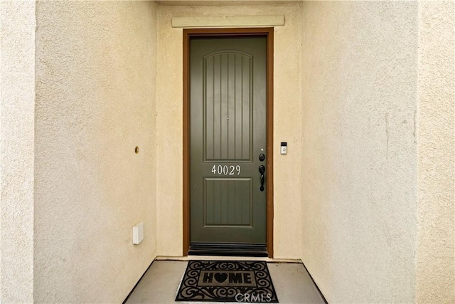 view of exterior entry with stucco siding