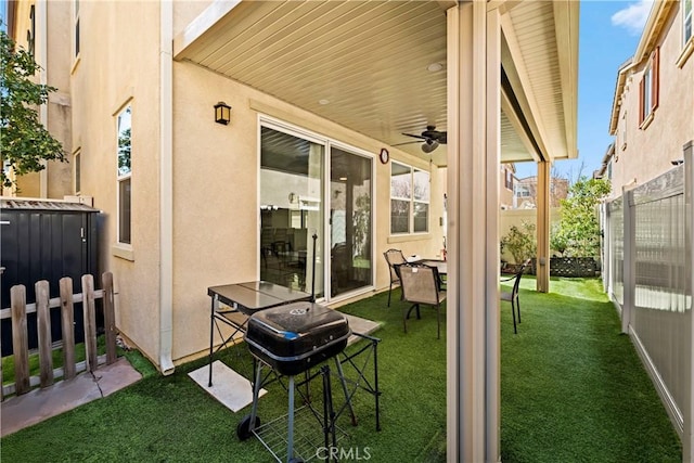 view of patio / terrace featuring a grill, ceiling fan, and fence