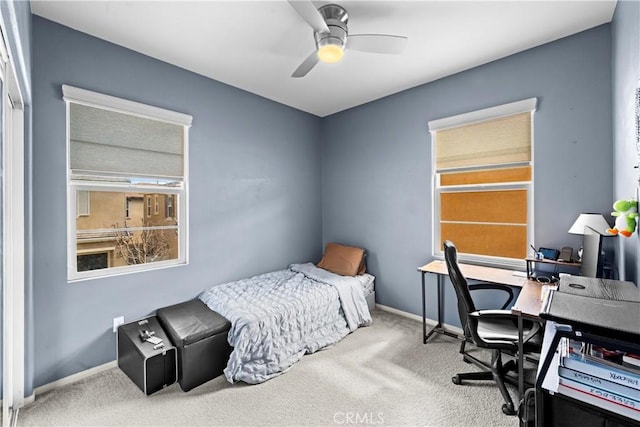 carpeted bedroom featuring baseboards and a ceiling fan