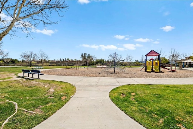 view of home's community featuring a yard and playground community