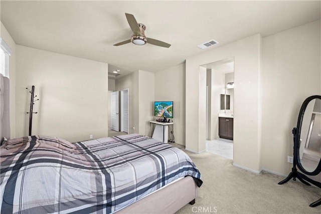 bedroom with visible vents, connected bathroom, baseboards, carpet, and a ceiling fan