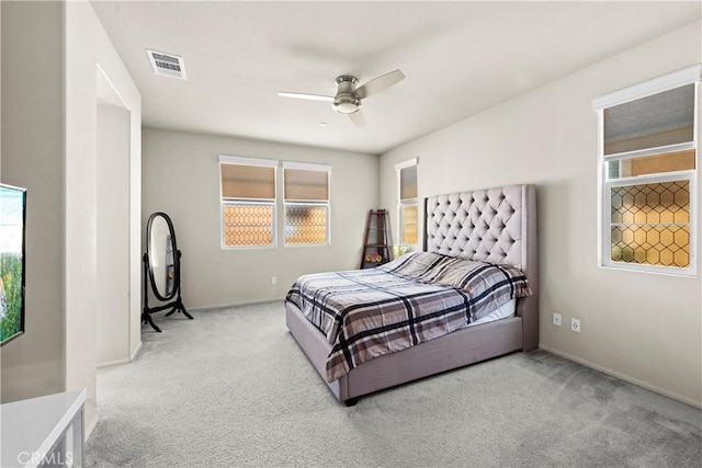 carpeted bedroom with baseboards, visible vents, and ceiling fan