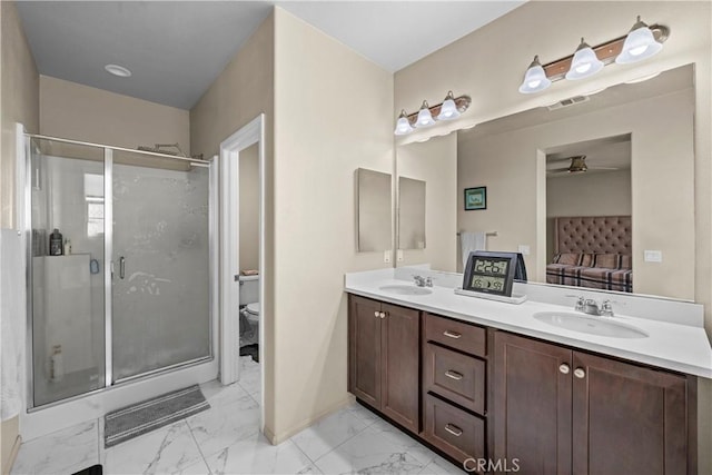 ensuite bathroom with connected bathroom, visible vents, marble finish floor, and a sink