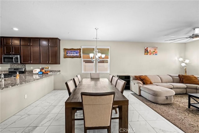 dining area with recessed lighting, marble finish floor, and ceiling fan with notable chandelier