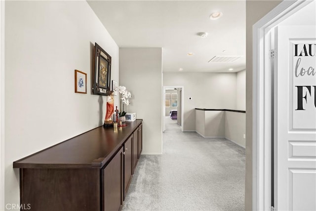 hall featuring light carpet, recessed lighting, and baseboards