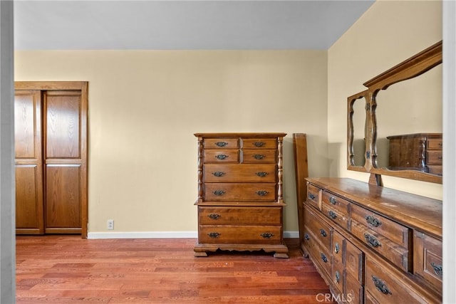 bedroom featuring baseboards and wood finished floors