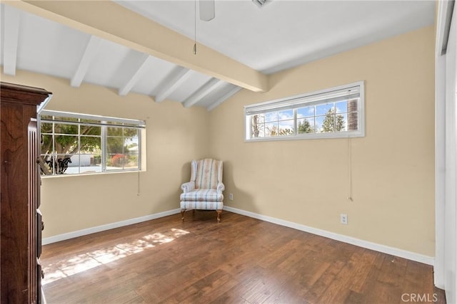 unfurnished room featuring vaulted ceiling with beams, wood finished floors, and baseboards