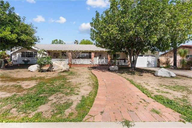 single story home featuring a porch and a garage