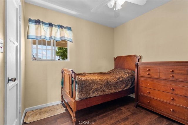 bedroom with ceiling fan, baseboards, and dark wood finished floors