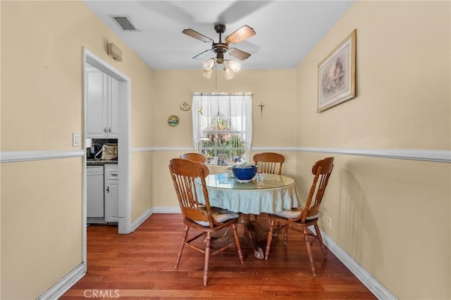 dining area with ceiling fan, visible vents, baseboards, and wood finished floors