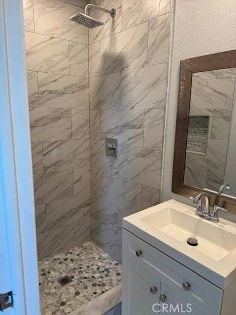 full bathroom with a stall shower and vanity