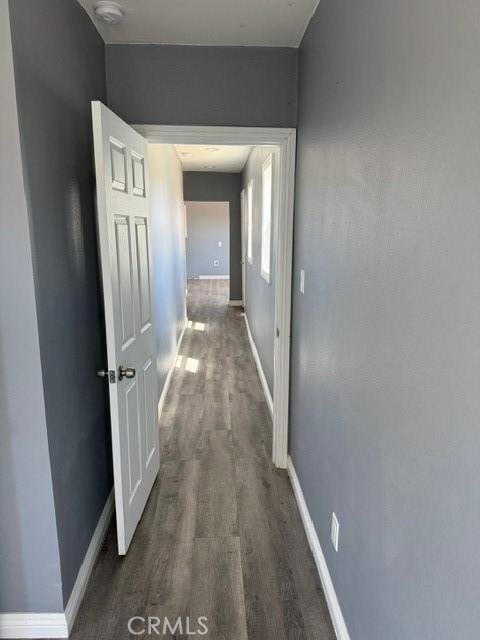 hall with baseboards and dark wood-style floors