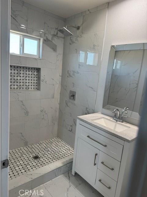 bathroom featuring vanity, marble finish floor, and a shower stall