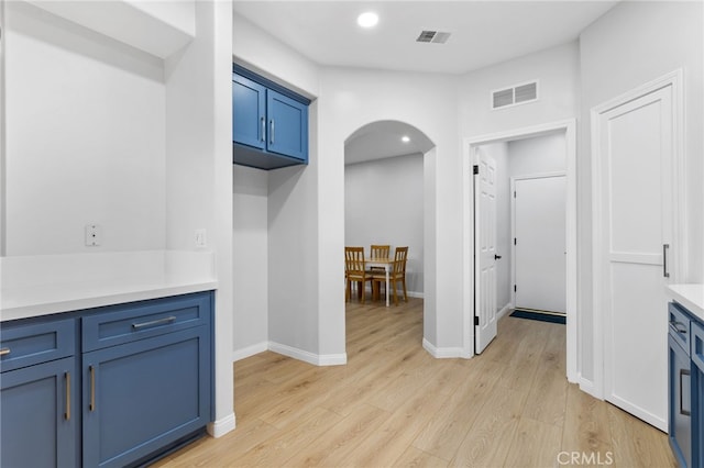 interior space featuring visible vents, recessed lighting, arched walkways, light wood finished floors, and baseboards