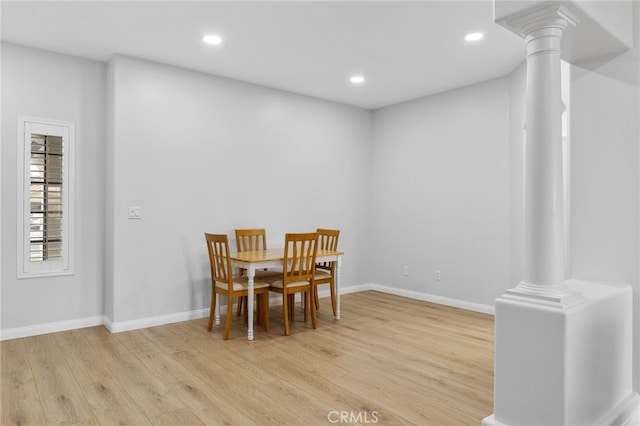 dining area featuring recessed lighting, light wood-type flooring, baseboards, and decorative columns